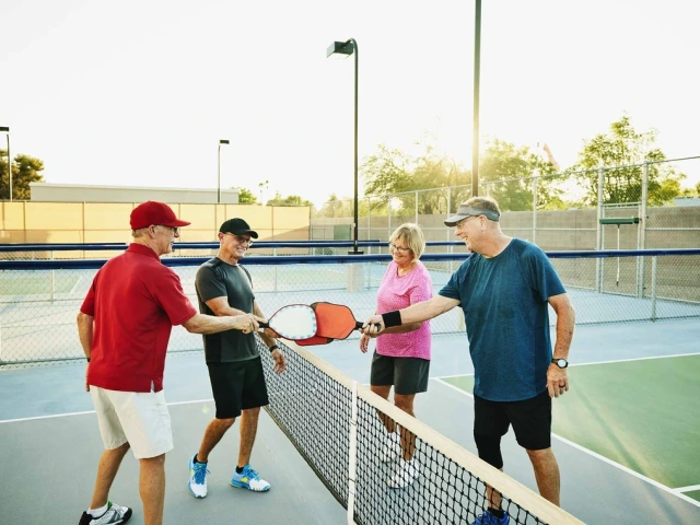 4 people playing pickleball